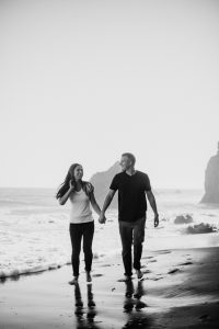 black and white engagement photo on the beach
